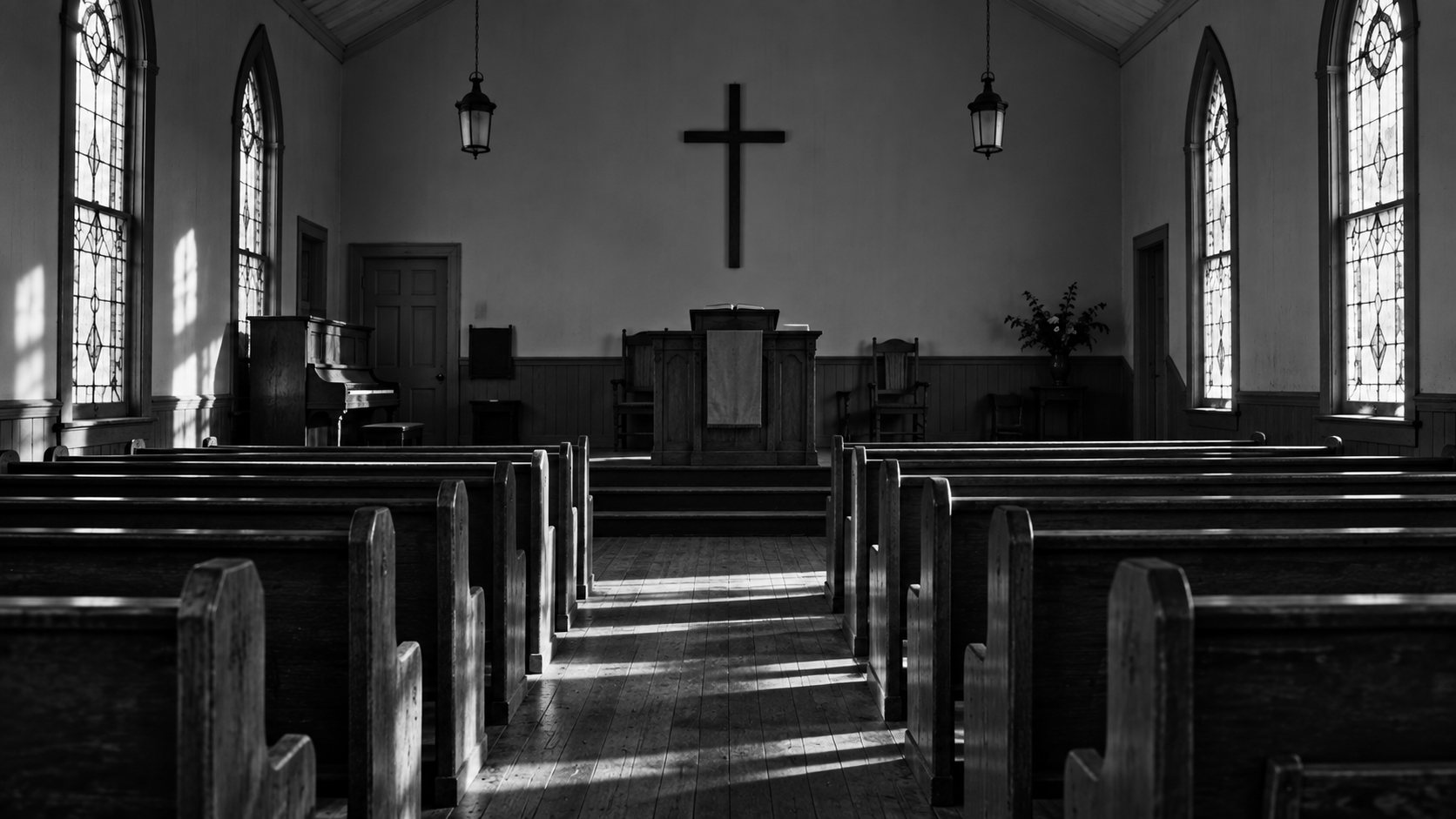 The interior of a small rural church, seen from the back pew toward the pulpit