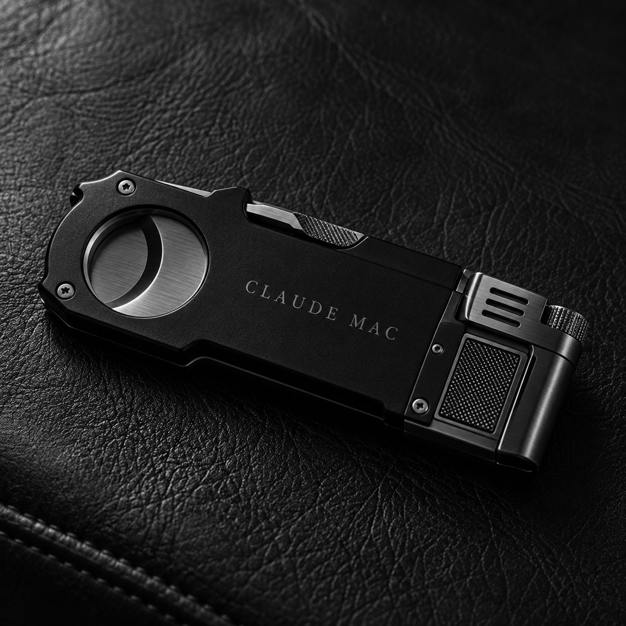 The Multi-Tool, closed on black leather, wordmark engraved along the body